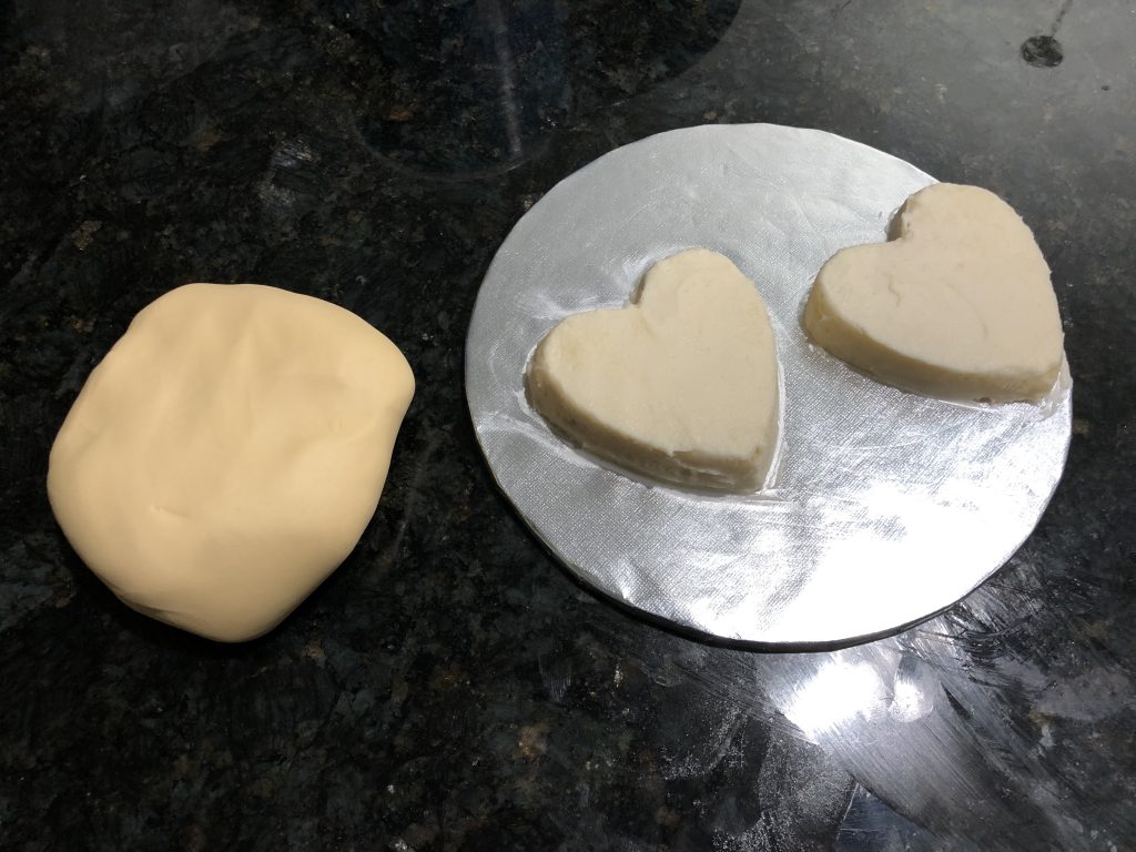 covering the heart shaped cake with fondant 