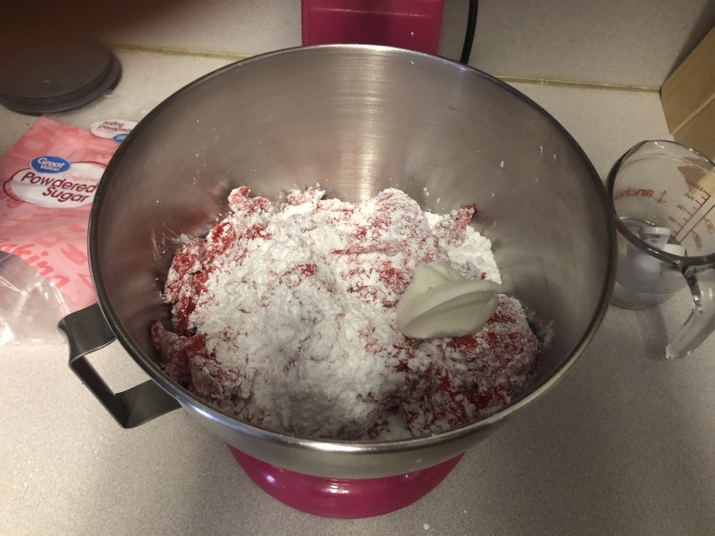 adding powder sugar to melted marshmallows