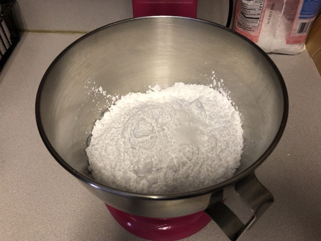 adding powder sugar to egg whites
