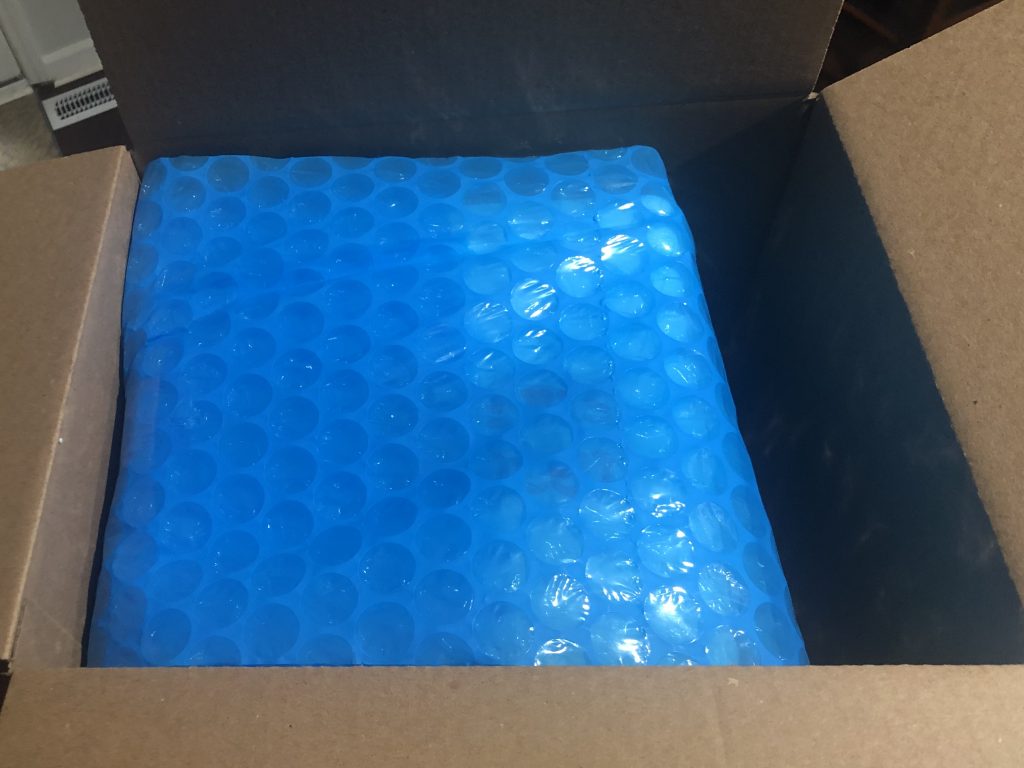 covering cooler in bubble wrap to be shipped 